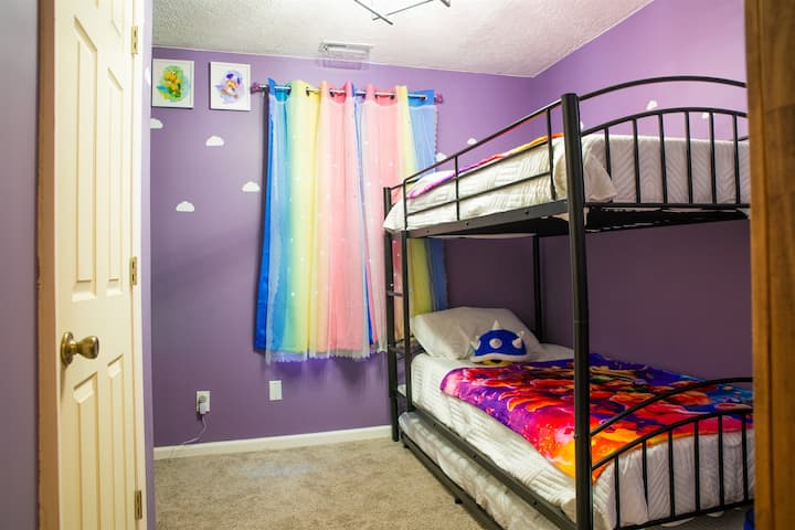 חדר השינה הזה מעוצב מתוך מחשבה על כולם. שילוב של סגול וכחול וכל מה שביניהם, עם נושא של סופר מריו! מיטות הקומתיים ממתכת מספקות מספיק כוח אפילו למבוגרים לישון עליהן.  בנוסף יש מיטת קיר!