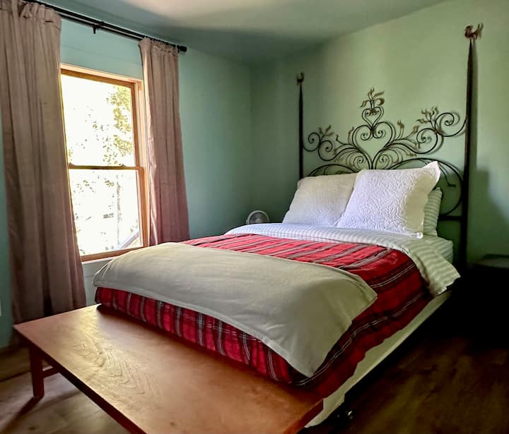 'Green' Bedroom with queen-size bed. Not seen: built in closet, wall mounted TV, extra shelving.