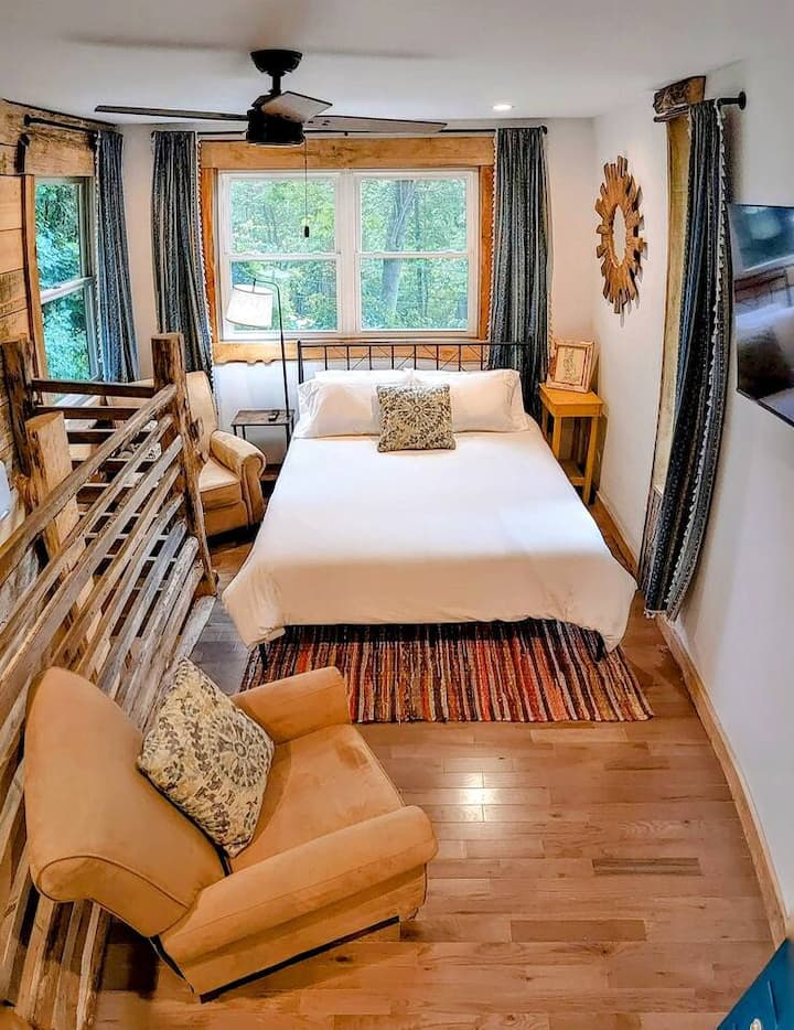 Upstairs there's a queen bed, two comfy arm chairs, and a flat screen TV on a swivel mount to watch from practically any angle