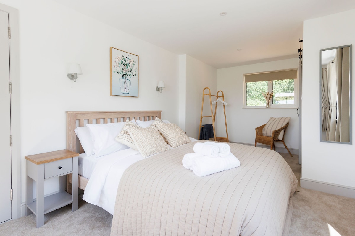 Amplio dormitorio principal con tonos neutros y abundante luz natural