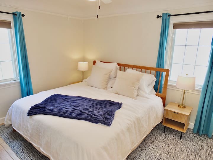 The tranquil master suite boasts a plush king bed & private ensuite