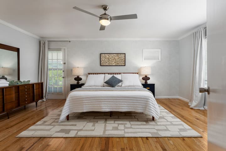 Bright and Cozy Master Bedroom with a ceiling fan