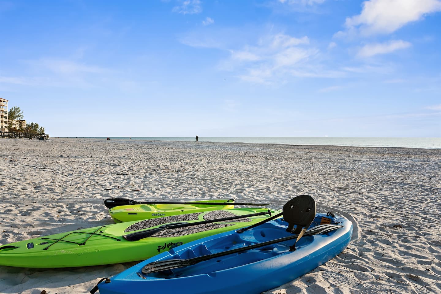 Kayaks and beach gear by the sand