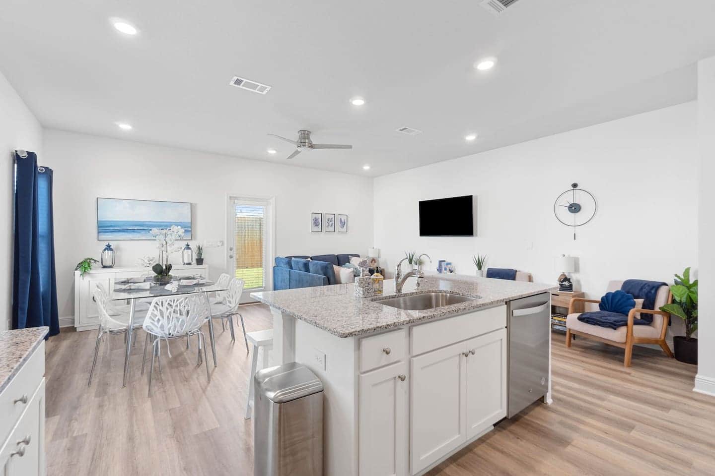 Relax in our charming open concept modern kitchen and living area, featuring large windows that invite abundant natural light throughout