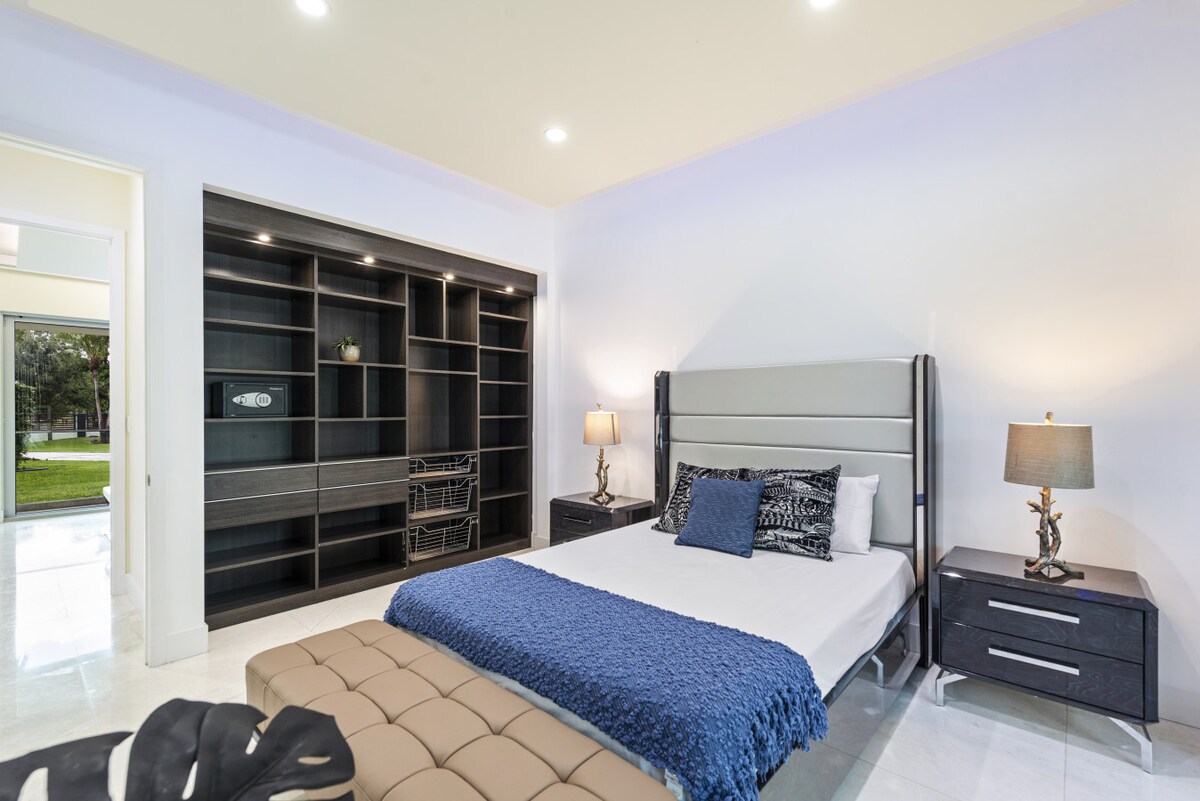 Habitación luminosa con estanterías de diseño en el armario y vistas al jardín