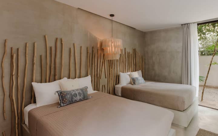 A relaxed bedroom with natural accents and a pendant light for gentle ambiance.