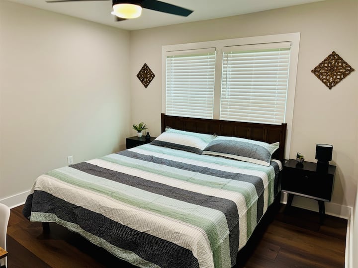 Bedroom 2 with Nectar King bed mattress, closet space, 43 in Smart TV and desk/desk chair.