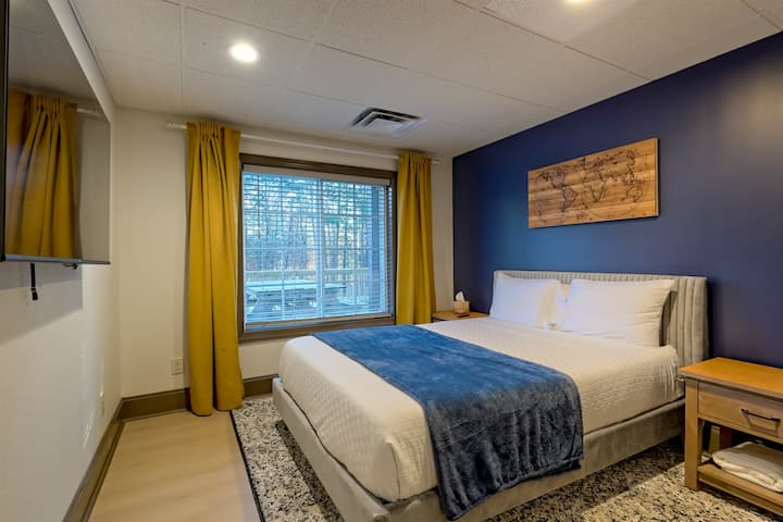 Cozy queen bedroom with plenty of natural light