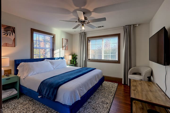 2nd floor king room featuring a large TV and cozy seating.