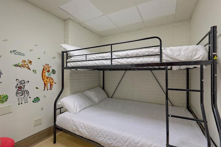 Kid-friendly bunk room with cute wall art and extra sleeping space.