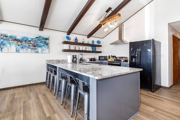 Granite Countertops and new stainless steel appliances grace this fully-stocked kitchen. Bar stools for entertaining and visiting while cooking.