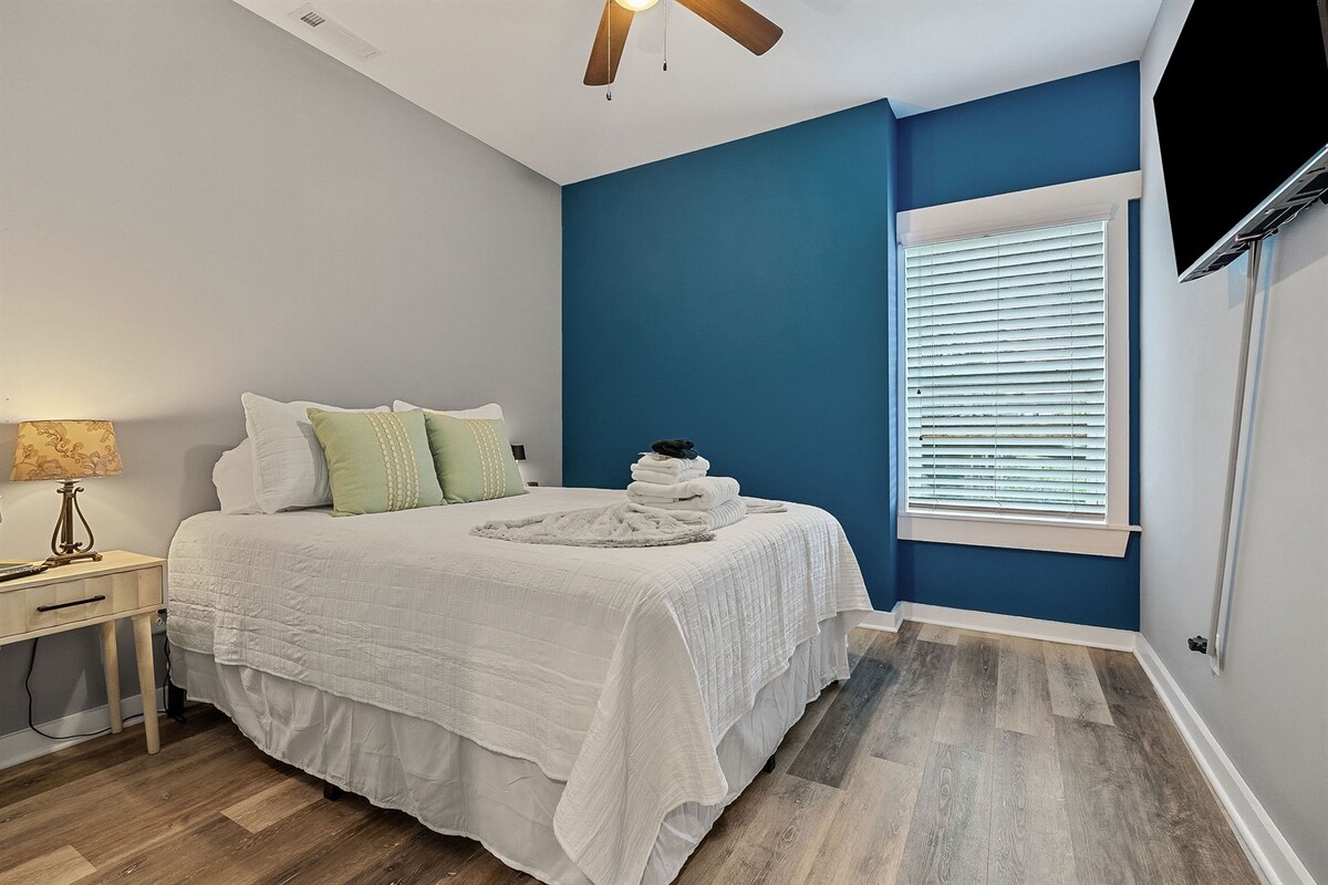 Comfortable queen bedroom with spacious closet and Smart TV.