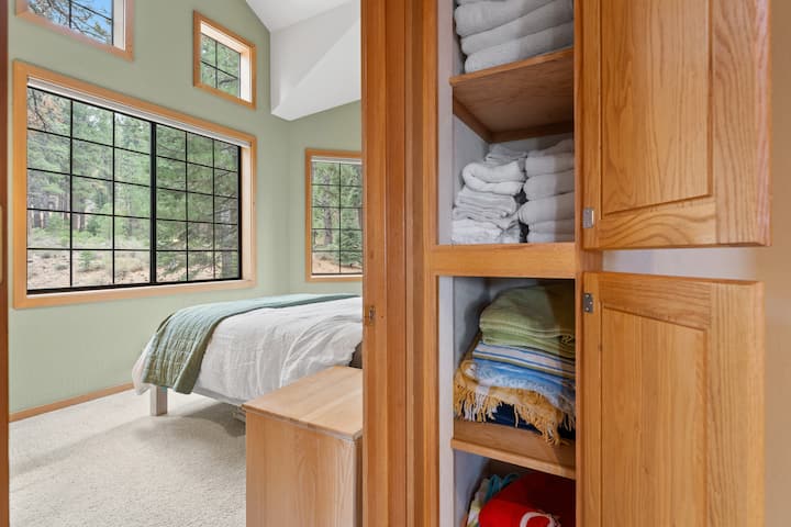 Upstairs queen bedroom with a beanbag and childrens books and beautiful views.
