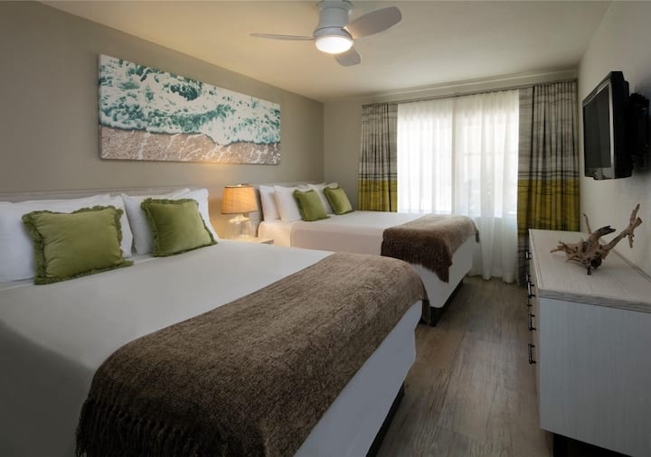 One-bedroom pool view suite featuring two queen beds.