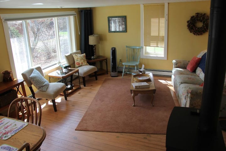 The sunroom faces the lake. You can lounge on the couch and watch the lake or the birds in the garden.  The dining area is in this room along with the indoor fireplace.
