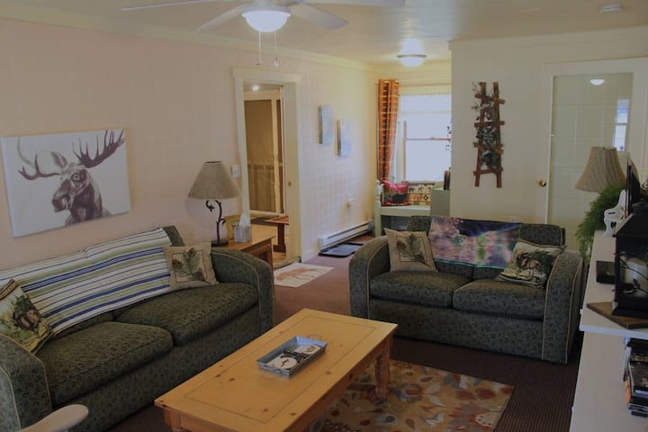 The family room is the first room you enter from the front door. There is a cozy book nook, tv, couch, loveseat, and chair.