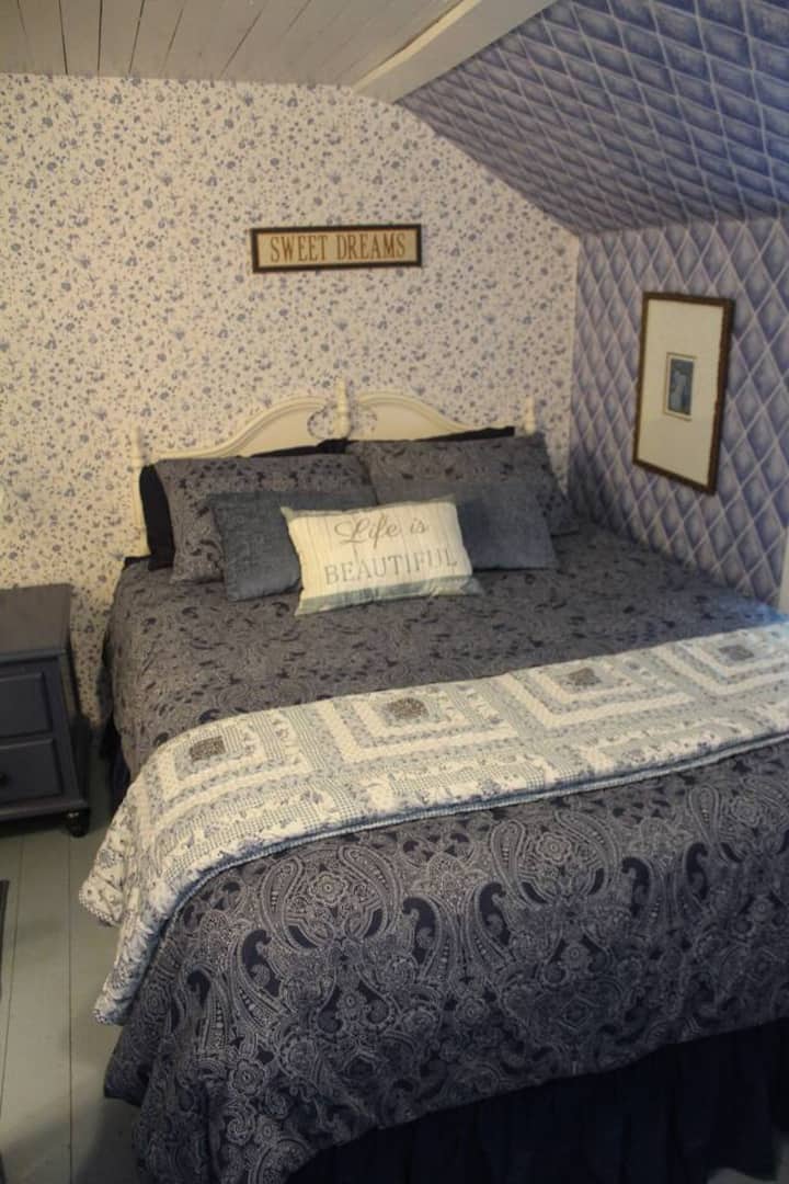 The blue bedroom is upstairs and features a queen sized bed and has the half bath right next to it.