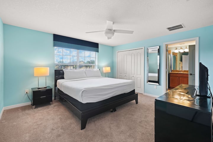 - Живописна спална соба со кревет со свежа бела постелнина и впечатлив тиркизен акцент на ѕидот - црните ноќни шкафчиња и светилките што одговараат го подобруваат современото чувство - прозорецот внесува природна светлина, истакнувајќи го удобниот тепих и пространиот распоред