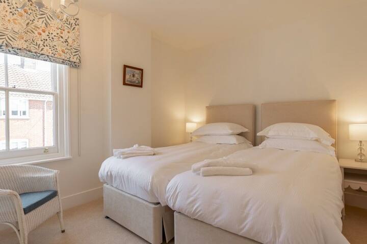 Twin bedroom with large window and pretty blinds.  Skylark is available to book with Durrants Holiday Cottages.
