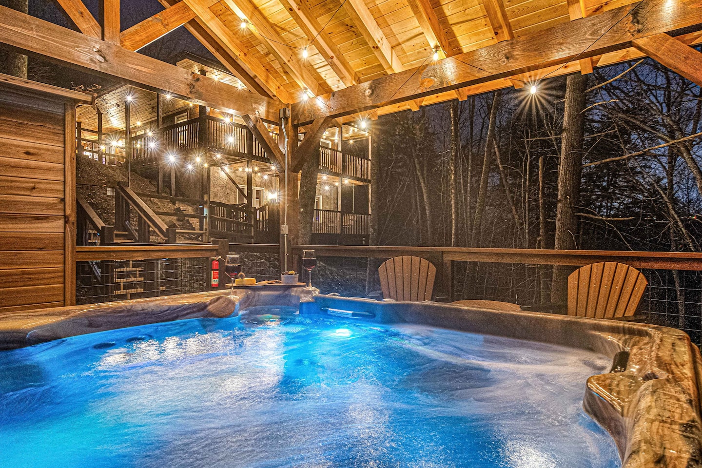 Hot tub glowing at night under the covered pavilion
