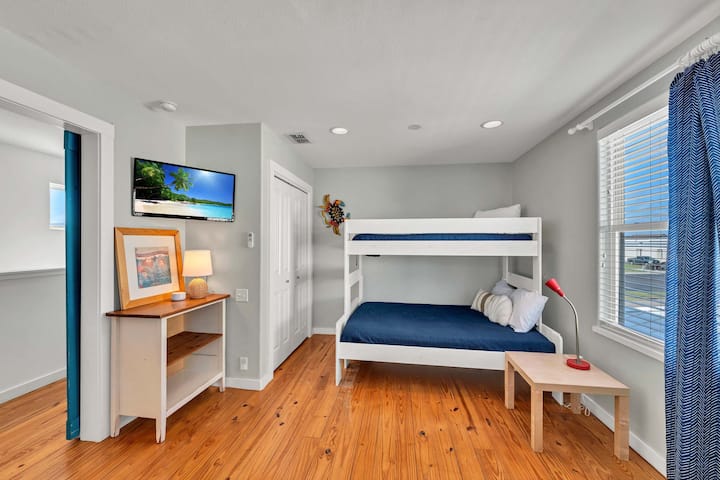Bunk room has two twin over full beds. Couch and TV with smart apps and cable TV, blinds, pack n play, and fans.