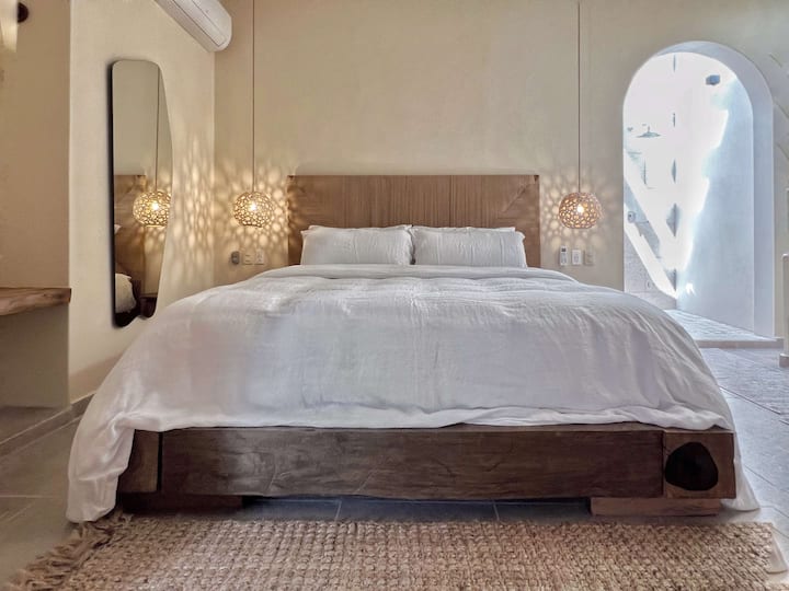 Cozy king bed wrapped in warm neutrals for restful nights