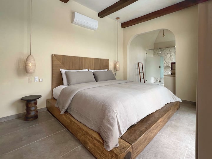 Cozy bedroom w/ warm tones & soft natural light