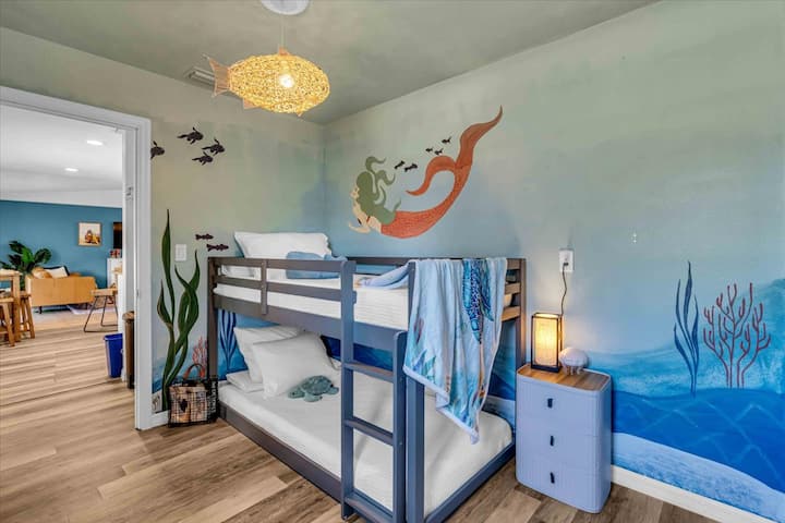 The Kids' Underwater Bunk Cove blends rest and adventure! Sleep beside a sea turtle, dolphin, and mermaid! Insta-approved!