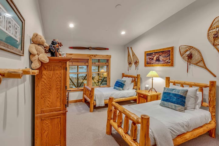 Bedroom 3:  2 twin beds, 1 chair, armoire, 32” Smart TV, main floor