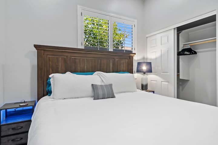 This bedroom offers plenty of closet space and features LED nightstands with built-in charging capabilities for your convenience.