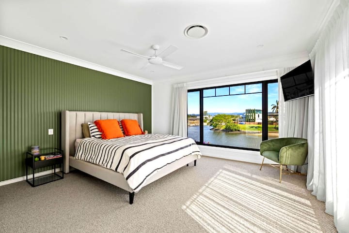 Retreat to the spacious master suite, featuring a private balcony, ensuite, and stunning water views.