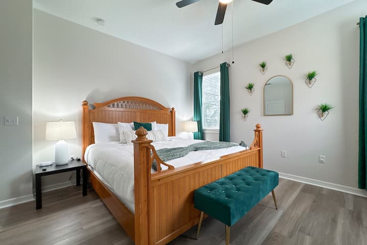 Primary Master Suite - Safari-themed primary bedroom with a king bed and workstation. Decorated with earthy tones, natural textures, and subtle accents that evoke a sense of adventure while providing a cozy and restful atmosphere