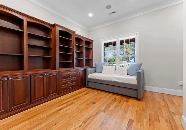 Main Level Twin bedroom with twin bed and trundle. Shelves have been converted to a take one, leave one library. 