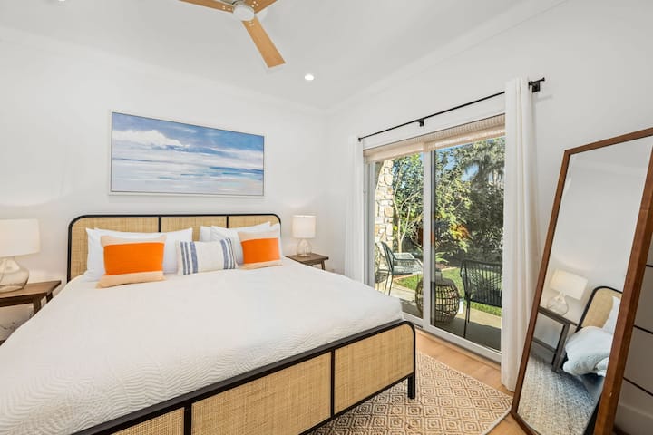 After entering the home, double french doors open to the 1st floor bedroom, complete with a comfortable new king-sized bed, luxury crisp white bedding, a full-length mirror, and private sliding door which opens to the front patio.