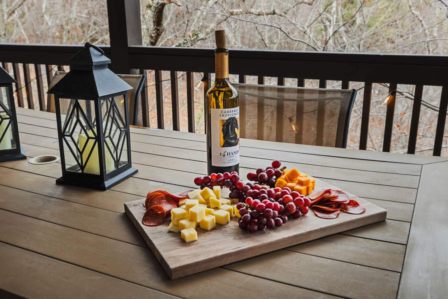 Pour the wine, light the lantern, and let the first course be whatever's on this board. Nobody's rushing to get inside tonight.