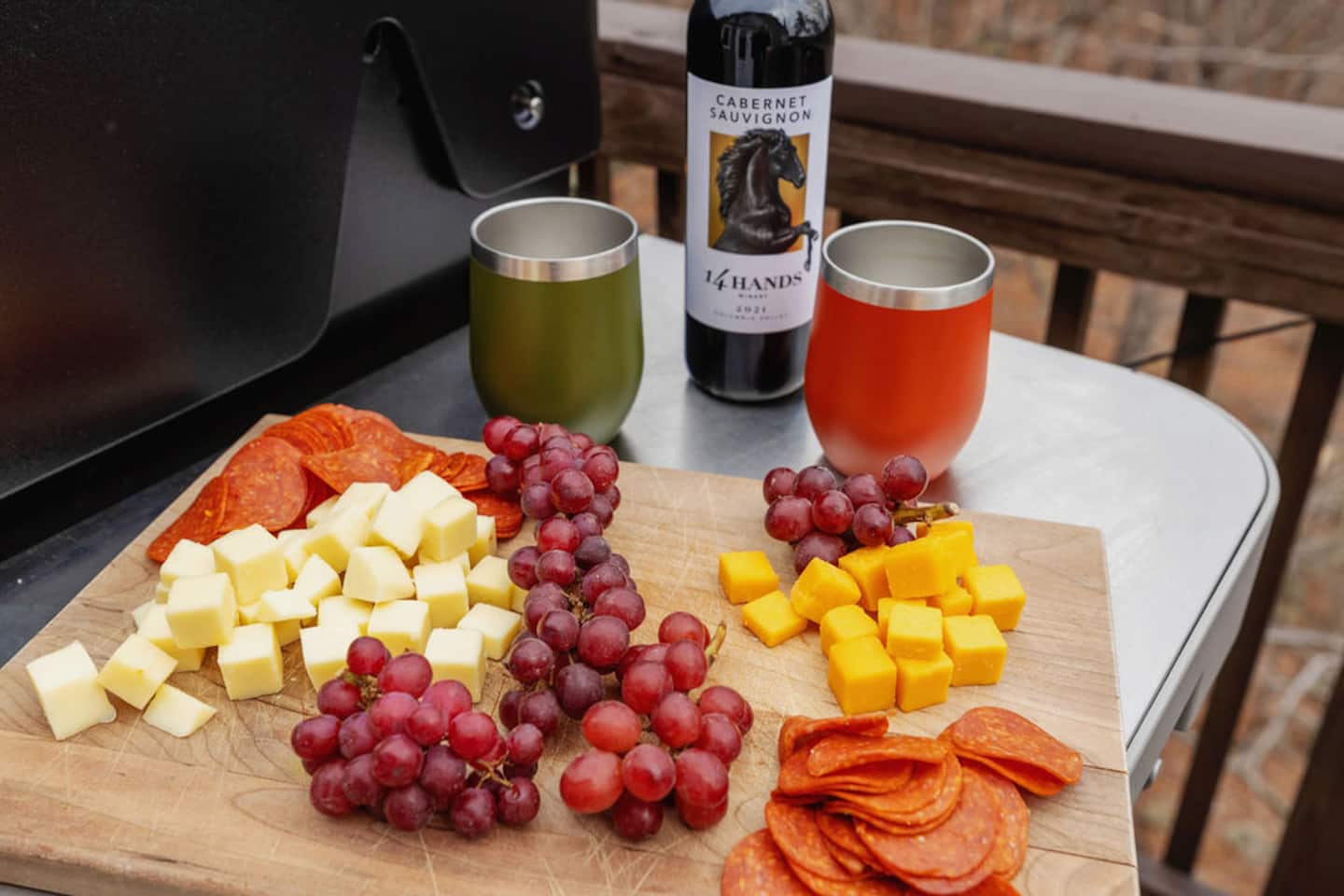 Set the cheese board out here and let people graze while the fire pit gets going. Two tumblers already out means somebody's pouring before