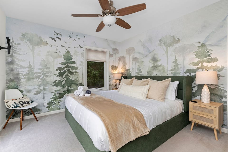 Misty Forest King bedroom with a chair by the window