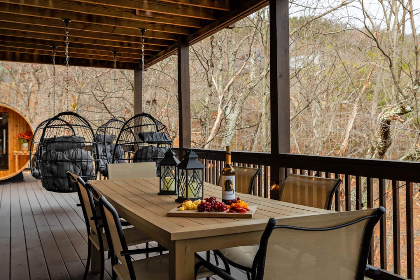 Take this lower deck once the upstairs one fills up. Pour a glass, light the lantern, and let the kids run the yard while you sit.