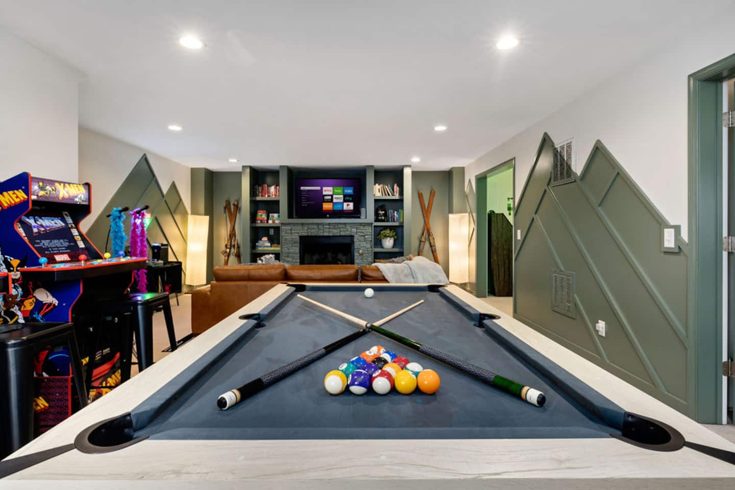 Take the pool table up front while the fireplace glows behind you. This whole level was built for a crowd.