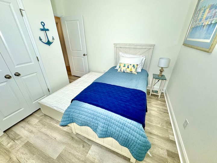 Twin trundle bed with blackout curtains. Linens for bottom twin trundle bed in closet. 