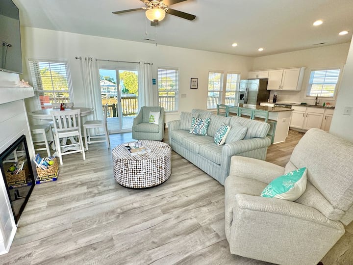Get cozy while you relax in this living room with a fireplace and water view. Sofa bed features a Queen mattress. 