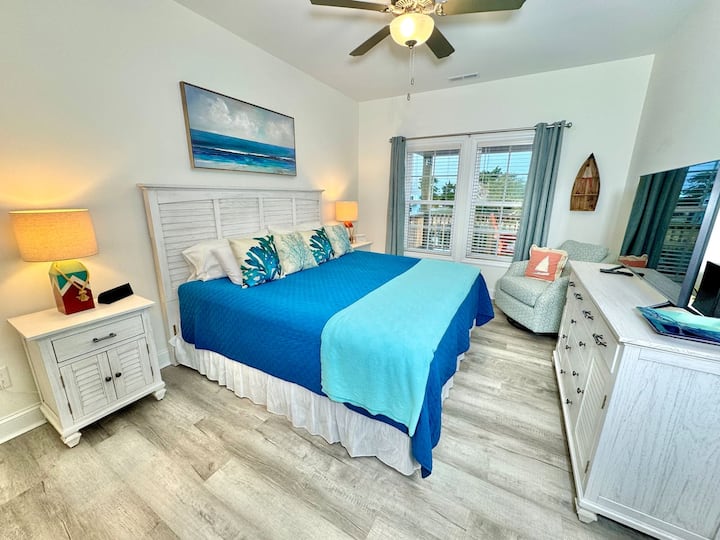 The master bedroom has a King bed, smart TV, blackout curtains, and water view.