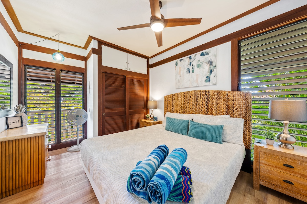 Bedroom w/ Jalousies open - Relax in style and let the gentle breeze from the windows wash over you!