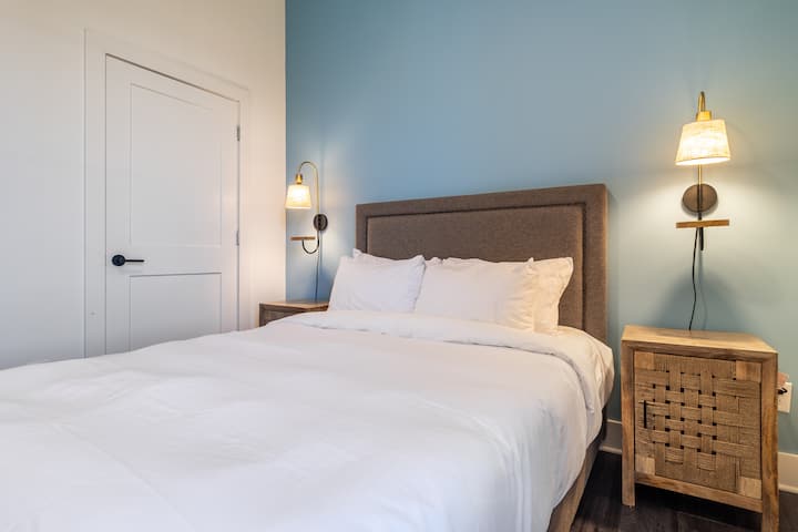 Bedroom 2 features a queen bed.