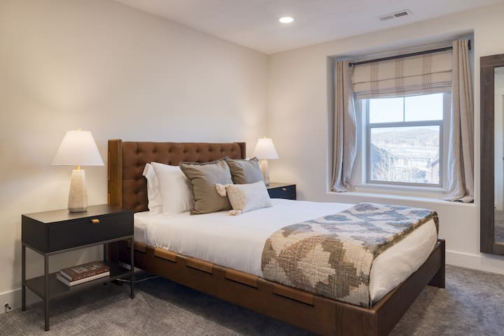 Bedroom 2 features a queen bed.