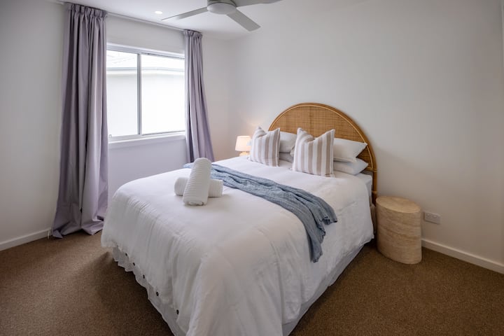 Bedroom 3 with queen bed, wardrobe and ceiling fan.