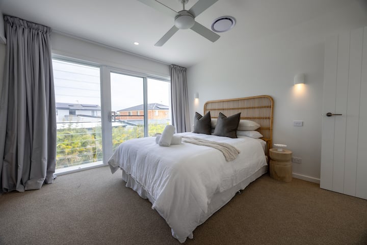 Master bedroom with ensuite, large walk-in robe, ceiling fan and smart TV.