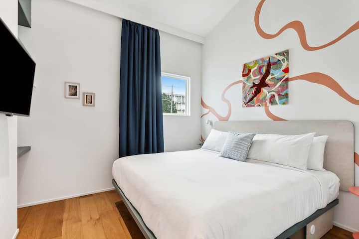 Bedroom 2: king bed, downstairs. The hall bath is steps away. Art: a tufted Fisk map of the Mississippi by Jess C.X.