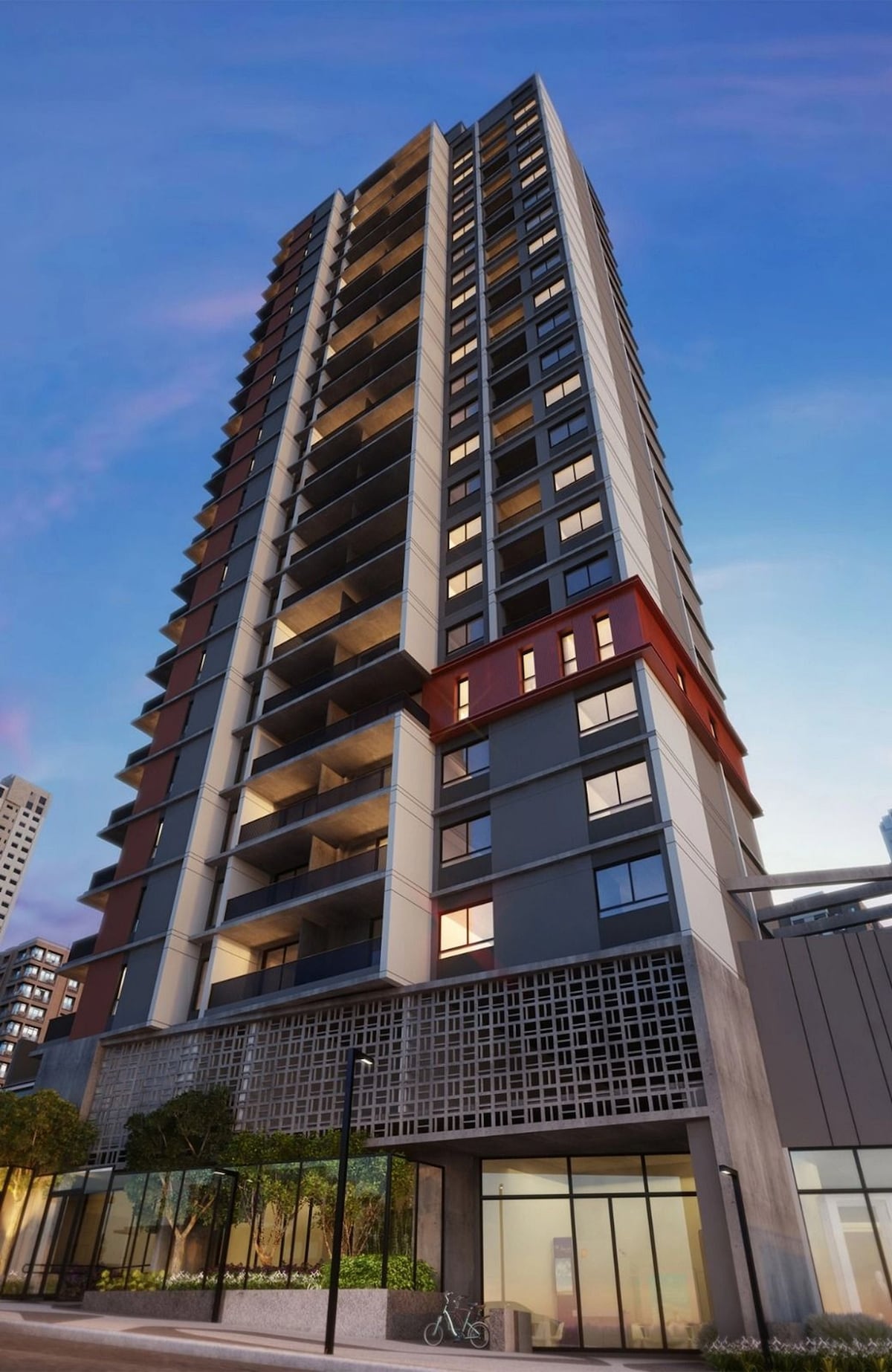 A modern multi-story building is presented, featuring a mix of light and dark architectural elements. The façade includes large windows and balconies, while the ground floor showcases an entrance framed by greenery and artistic detailing, contributing to an inviting urban atmosphere.