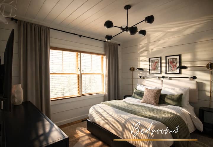 Bedroom 3 is light and bright, with a queen bed and a clean palette that keeps things airy and calm.